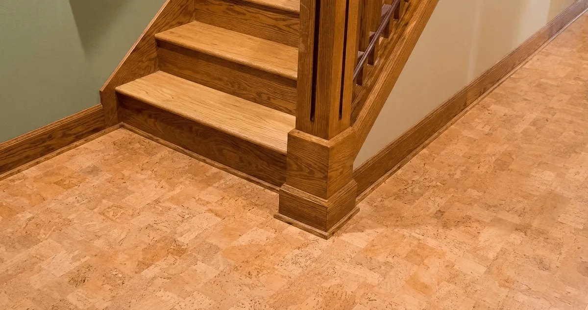 End of a staircase with cork flooring in Rochester, NY