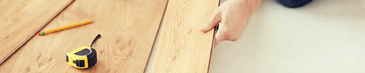 A professional installing wood flooring in Rochester, NY