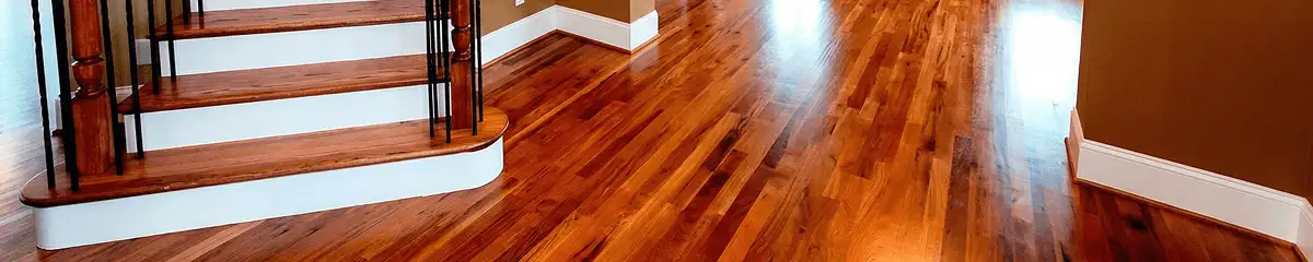 Base floor of a staircase with professionally restored wood flooring in Rochester NY