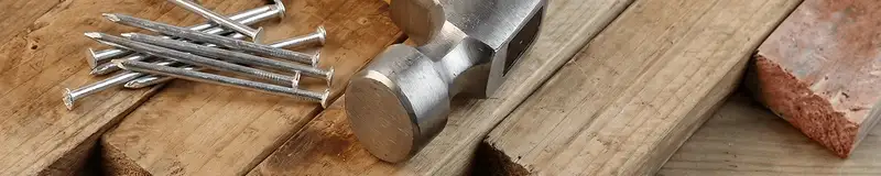 Hammer and nails on hardwood flooring boards in Rochester, NY