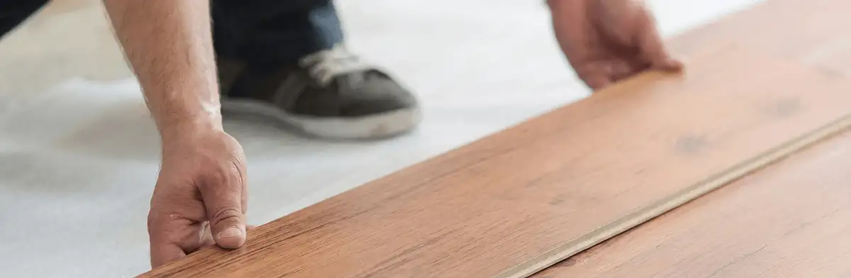 A professional installing laminate flooring in Rochester, NY