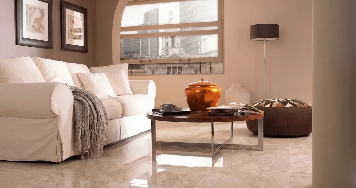 Modern living room with professionally installed marble flooring, a beige sofa, coffee table in Rochester, NY