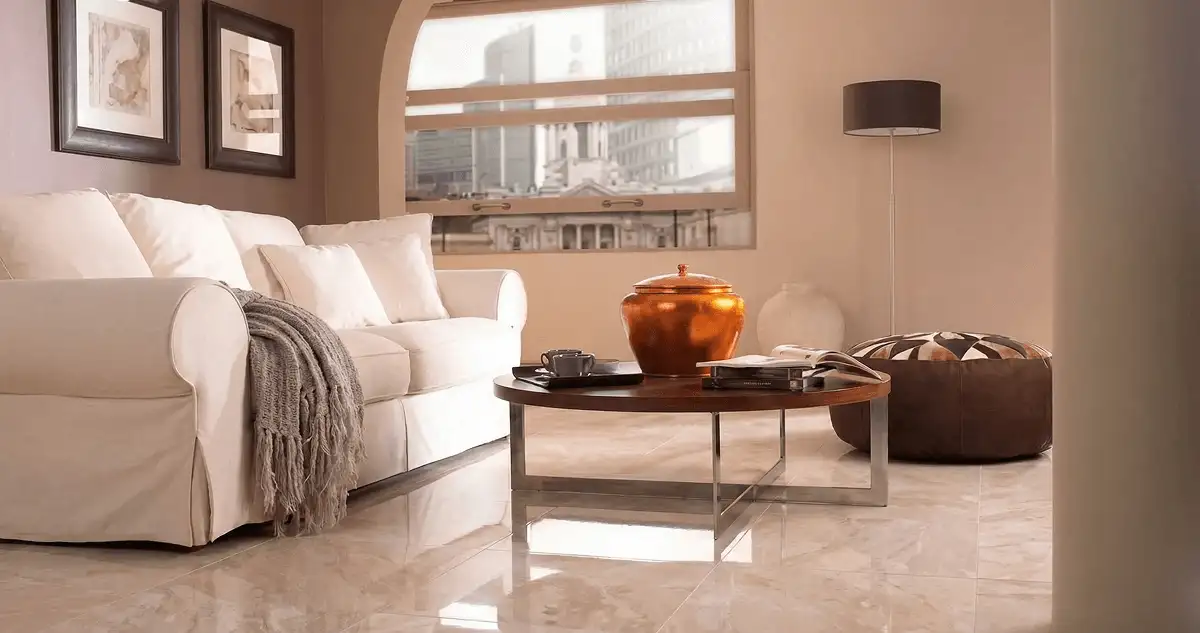 Modern living room with professionally installed marble flooring, a beige sofa, coffee table in Rochester, NY
