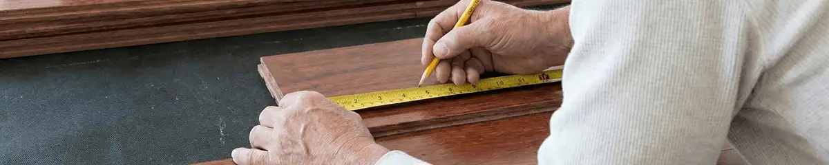 A professional installing wood flooring in Rochester, NY